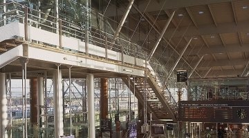 All glass panoramic lift for a train station