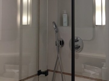 Anti-corrosion toughened glass for a shower stall